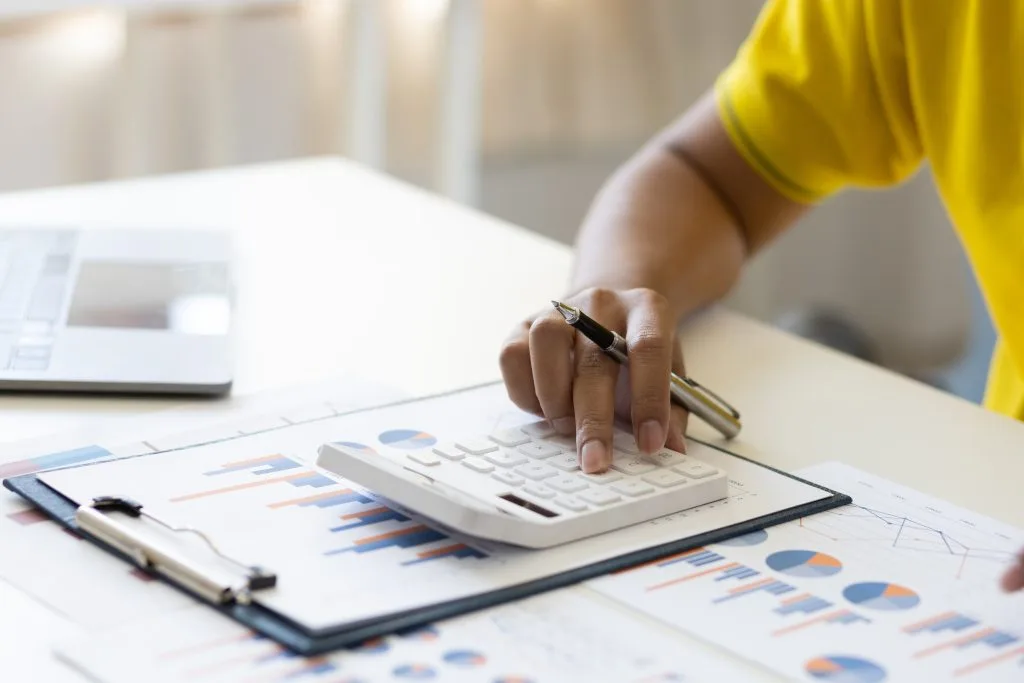 A person reviews graphs and charts while calculating data related to the privacy policy